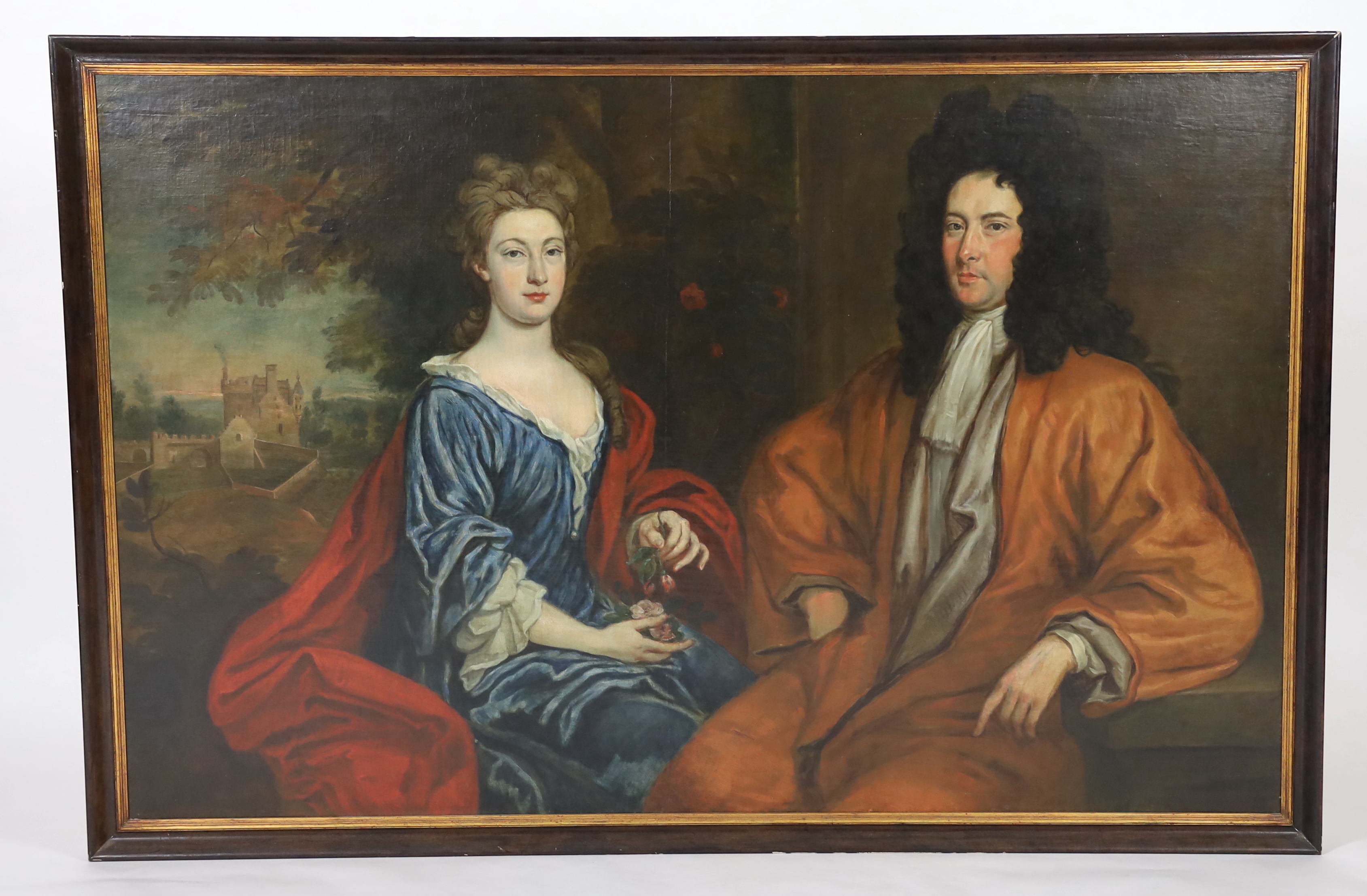 Follower of Michael Dahl (Swedish, 1656-1743), oil on canvas laid on board, Double portrait of a husband and wife with a country house beyond, 116 x 181cm